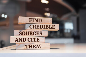 Wooden blocks with words 'Find credible sources and cite them'. - obrazy, fototapety, plakaty