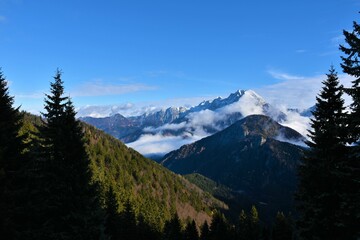 View of Kočna mountain with fog in Kokra valley bellow in Gorenjska, Slovenia