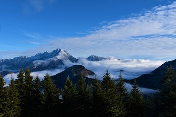 View of Kočna mountain in Kamnik-Savinja alps in Gorenjska, Slovenia with fog in the valley bellow