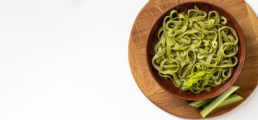 transparent broth with homemade noodles, in a ceramic bowl, and white background, empty space for text, top view