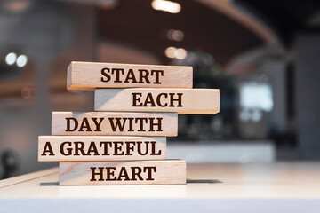 Wooden blocks with words 'Start Each Day With a Grateful Heart'.
