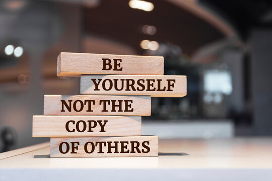Wooden blocks with words 'Be Yourself Not The Copy Of Others'.