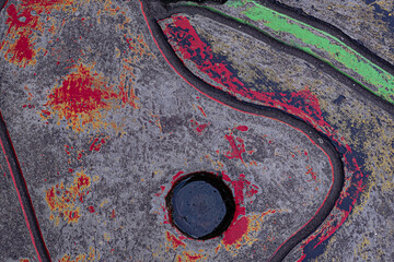 Concrete pavement with water filled hole and painted abstract design background and wallpaper texture