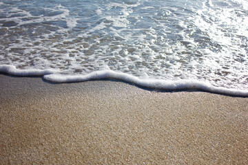 Fototapeta na wymiar Wave on the sandy beach