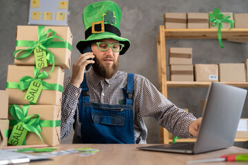 Small business owners, startup and e-commerce. man in leprechaun hat manage online store, business...