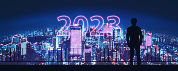 New Year 2023 Business man with metaverse neon city technology background