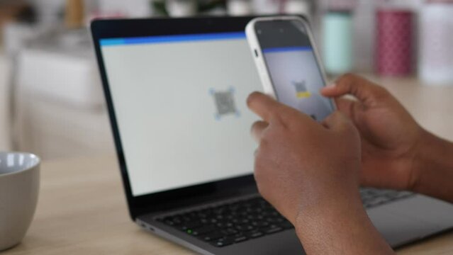 Reading a QR code from a laptop screen using a smartphone. Fast payment for goods and services, convenient online shopping.