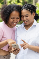 Happy smiling African woman using smartphone with positive mood, concept image of online sale, good online security data protection, fast signal connection