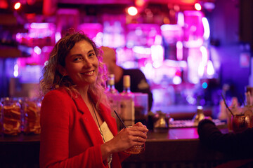 portrait latin mid adult woman in a pub smiling happy 