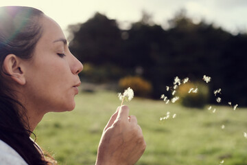 Native american woman blowing dandelion