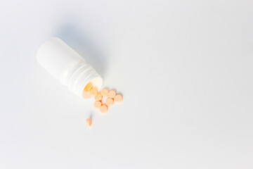Vitamin D3, Orange Medical Tablets with Bottles on a White Background. Right Copy Space