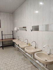old faucets and sinks in a public toilet