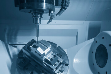 The 5-axis CNC milling machine  cutting the metal mold part.