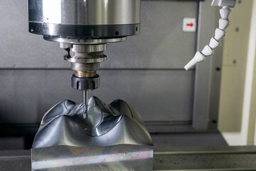 The CNC milling machine cutting injection sample part by solid ball end mill tool.
