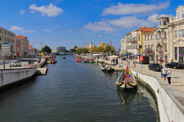 Fototapeta na wymiar Colorful traditional boats in the canal of Aveiro, Portugal.
