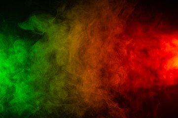 Plakat Red yellow green smoke on a black background.