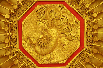 Fototapeta na wymiar Amazing Chinese Phoenix Wood Carving on the Ceiling of a Chinese Buddhist Temple