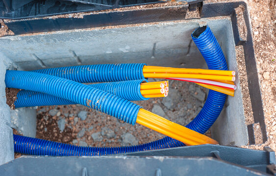 Pvc conduit for fibre optic cables in an open concrete shaft in the street for the construction of the fibre optic infrastructure