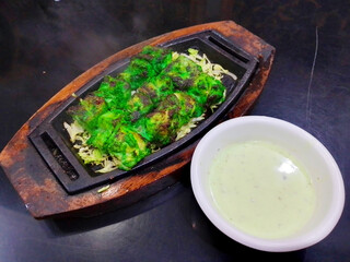 Hot Chicken Fried Green Botti with sauce in wooden tray