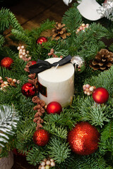 candle, red shiny balls, fir branches, festive decor