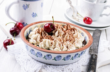 Traditional Swiss cherry pie with meringue topping served as close-up in a baking form