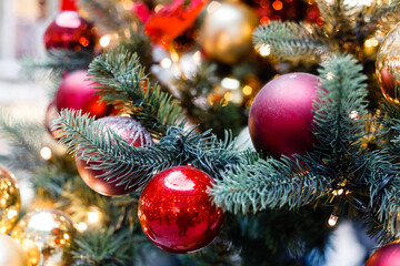 Close up of balls on christmas tree. Bokeh garlands in the background. New Year concept.