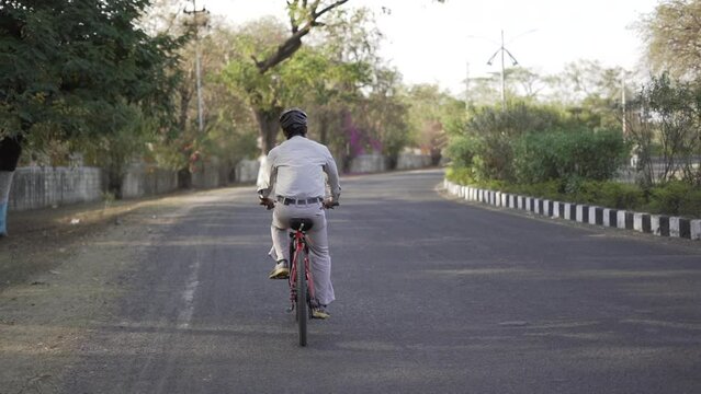 Indian men cycling to office