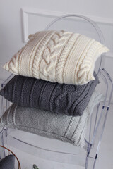 Beautiful knitted light pillows and balls of thread for knitting