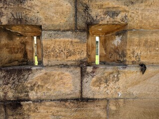 A close up view of a sandstone building made of hand  hewn blocks by early convicts on Cockatoo Island, NSW, Australia.