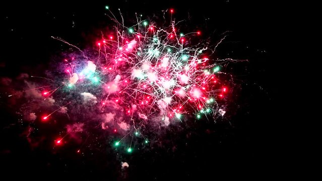Real Firework close up on Deep Black Background Sky on Fireworks festival before new year party 2023 , Independence day and Christmas eve concept. High quality 4k video