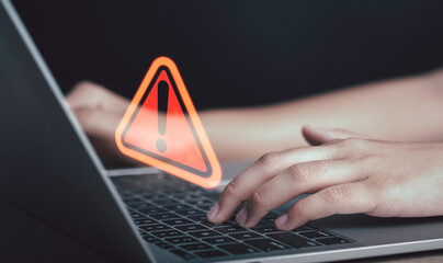 Triangle caution warning sign on laptop screen and Businessman or it staff , programmer, developer...