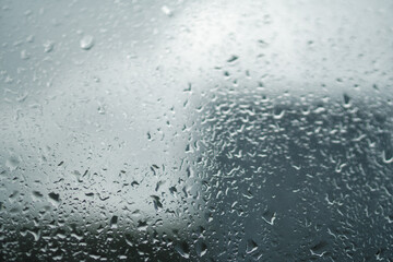 raindrops on the window pane. Gray color. Cloudy weather