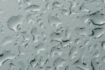 raindrops on the window pane. Gray color. Cloudy weather