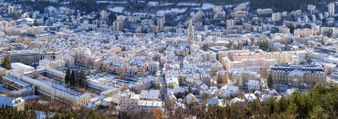 Elevated panoramic view of snow covered rooftops in the city of Gap in winter. Hautes-Alpes, Alps,...