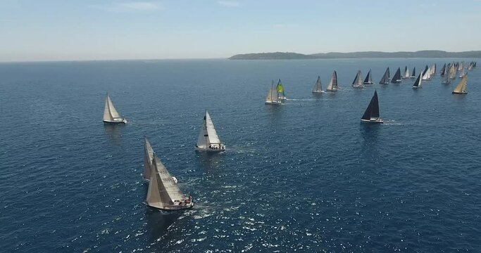 aerial view start of the Rolex Giraglia 2019 regatta, many sailing yachts have started and are making maneuvers
