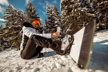 Portrait of snowboarder at top of ski slope