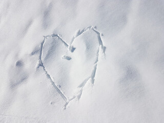 heart symbol written in the white snow cover
