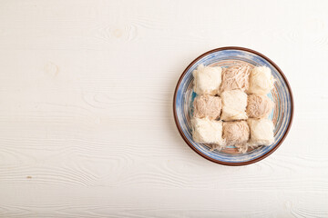traditional arabic sweets pishmanie on white wooden, top view, copy space.
