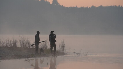 hunting by the creek in the forest. And hunting birds. Hunter hunting at sunrise