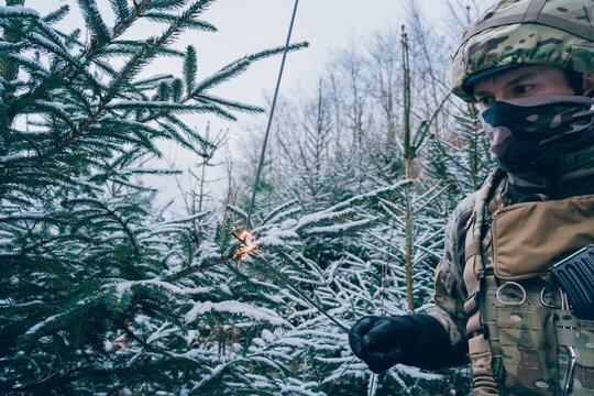 Soldier decorates a Christmas tree. The season of Christmas in a time of war. 