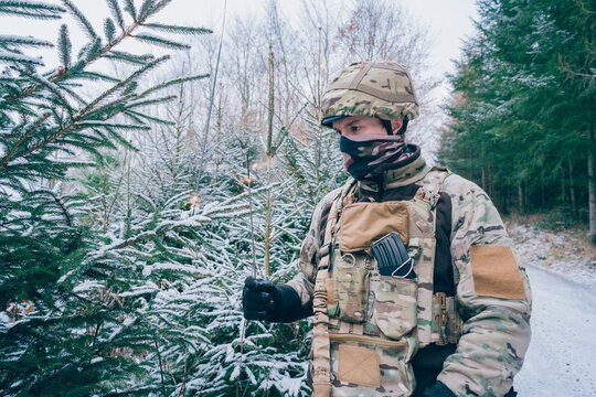 Soldier decorates a Christmas tree. The season of Christmas in a time of war. 