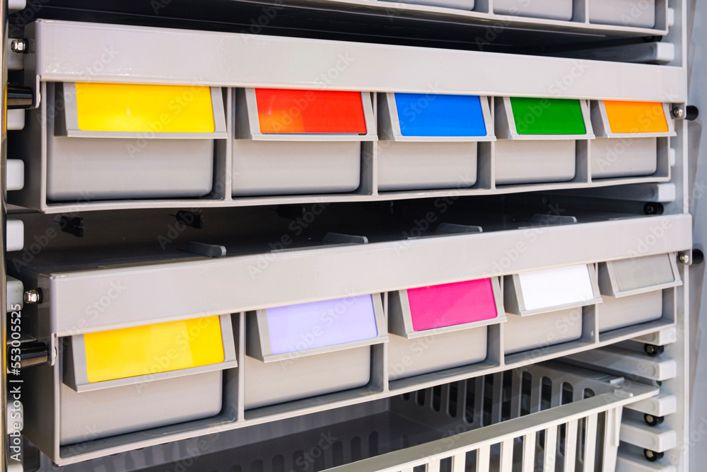 Poster rows of multicolored plastic boxes for components