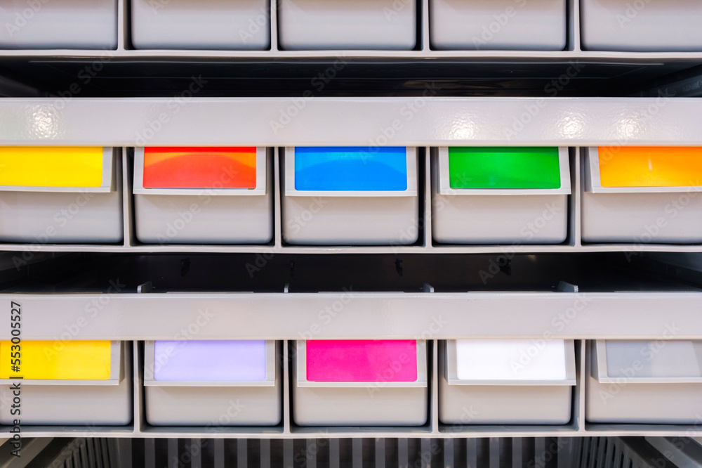 Poster rows of multicolored plastic boxes for components