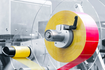 Fragment of the conveyor of sticking labeling machine. Abstract industrial background.