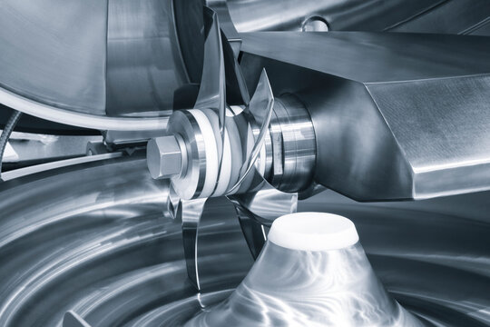 Industrial open food meat  mixer with knives in food industry close-up