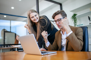 business team celebrate corporate victory together in office, laughing and rejoicing, smiling excited employees colleagues screaming with joy in office.