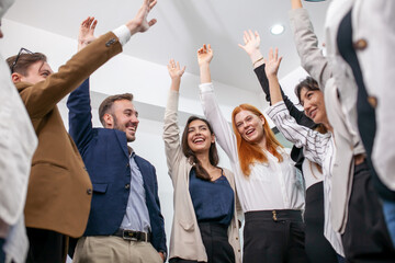 business team celebrate corporate victory together in office, laughing and rejoicing, smiling excited employees colleagues screaming with joy in office. - 553006502