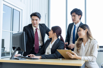 A group of young Asian businessmen Talking and planning work happily and have fun. at the company's office