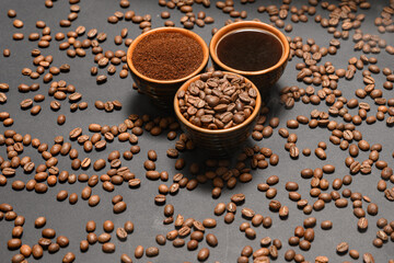 Set of three cups of coffee beans, ground and drink on a black background.
