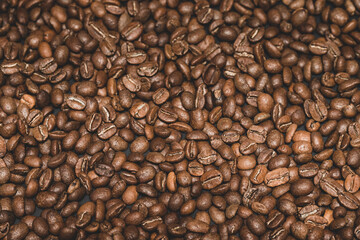 Texture of roasted coffee beans close-up, brown beans.
